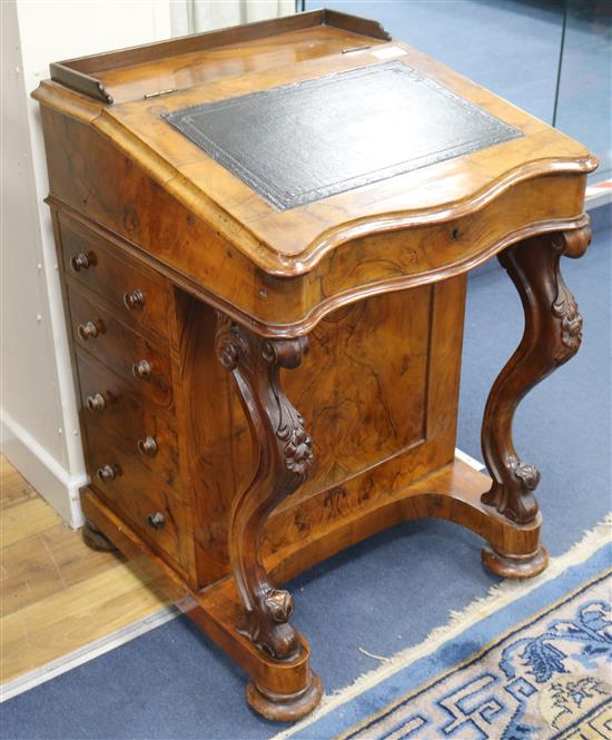 A mid Victorian walnut serpentine fronted davenport desk, H.80cm